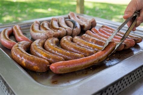 Image of Cooking sausages on a barbecue - Austockphoto