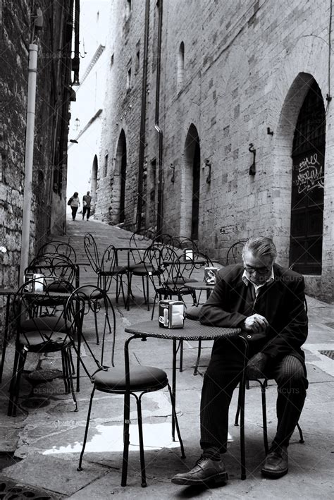 Well Dressed Man Sits Outside At Cafe In Old Italian Alley - Design Cuts