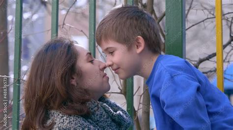 Son and mom kissing. Mother kiss her son outdoor Stock Video | Adobe Stock