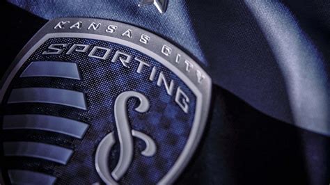 Download Sporting Kansas City Logo On Blue Jersey Wallpaper | Wallpapers.com