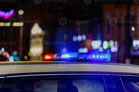 police car lights at night in city with selective focus and bokeh ...