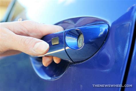 What Is That Tiny Button on the Car Door Handle? - The News Wheel