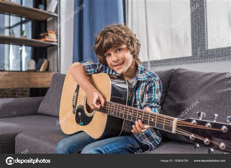 Child playing acoustic guitar — Stock Photo © AlexLipa #163604704