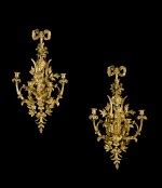 A pair of French gilt-bronze five-light wall appliques, attributed to Pierre-François and Lucien ...