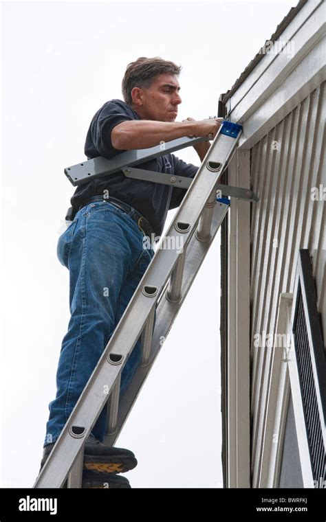 Installation of a residential wind turbine is filmed for an episode of ...