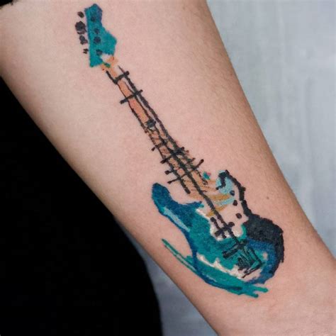 Crayon effect bass guitar tattoo located on the inner