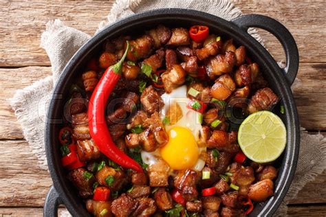 Sizzling spicy pork sisig with egg ang ... | Stock image | Colourbox