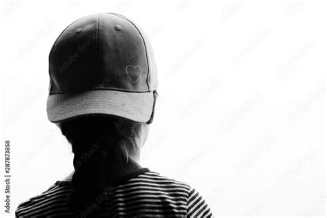 Girl Wearing Baseball Hat in Silhouette Stock Photo | Adobe Stock