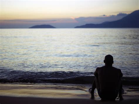 Man Sitting Alone On A Beach Photograph by Win-initiative/neleman ...