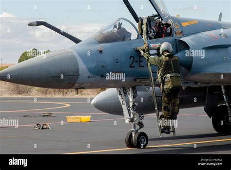 A pilot climbs into the cockpit of a French Air Force Mirage 2000 ...