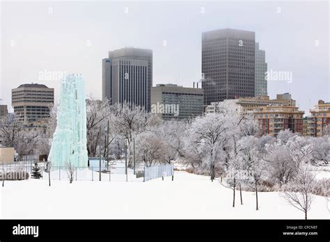 Downtown Winnipeg skyline on a frosty winter day. Ice climbing tower in ...