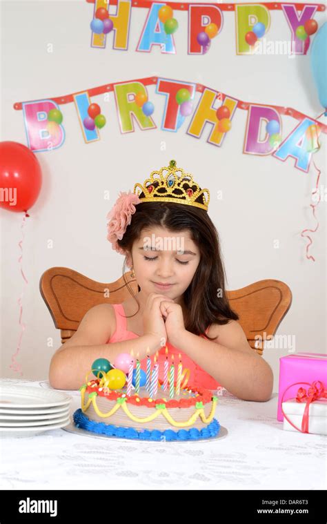 Little girl making birthday wish Stock Photo - Alamy