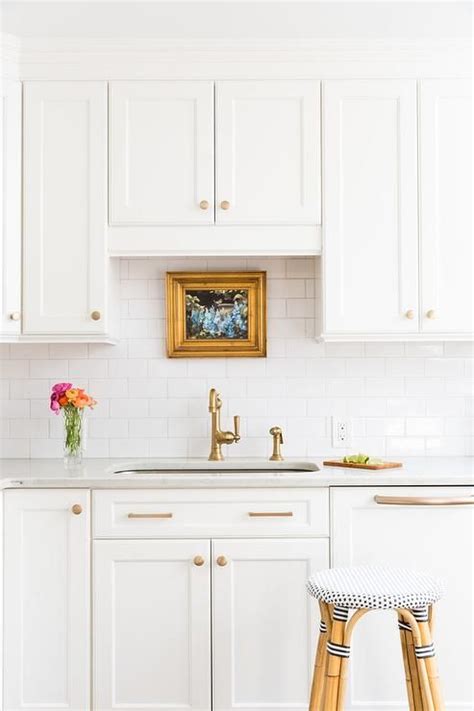 white kitchen cabinets with gold handles - sol-mezquita