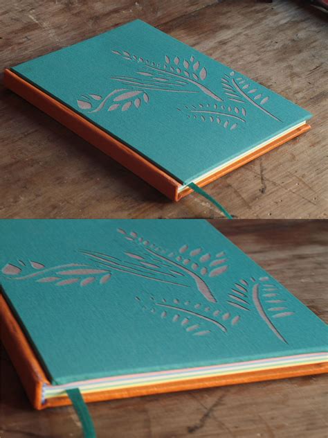 two different views of the inside of a green notebook on a wooden table with scissors