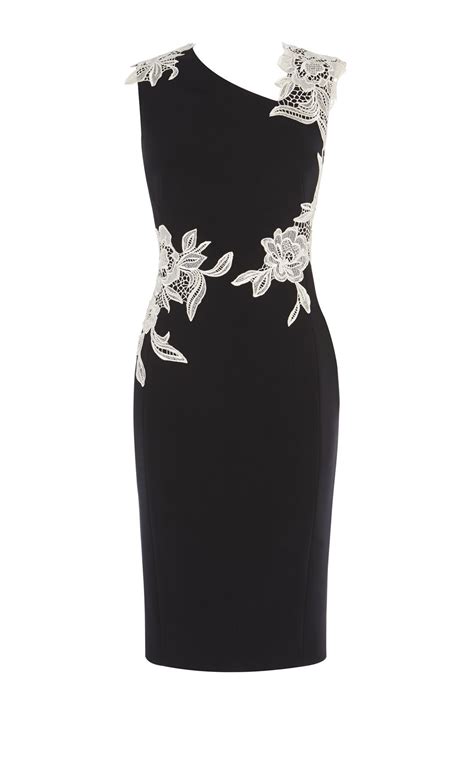 Black pencil, shift dress with ivory floral embroidery around the neck ...