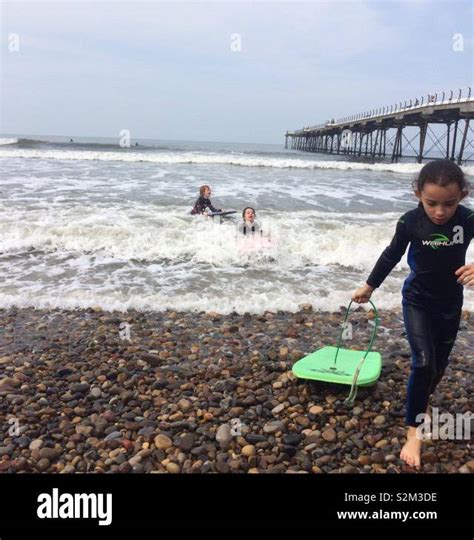 Kids boogie boarding Stock Photo - Alamy