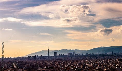 Tehran skyline in a beautiful cloudy day with golden hour light Tehran-Iran cityscape with Milad ...