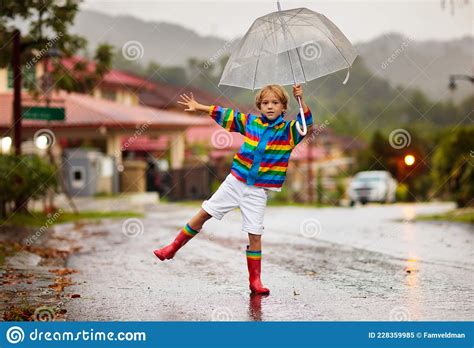 Child Playing in Autumn Rain. Kid with Umbrella Stock Image - Image of ...