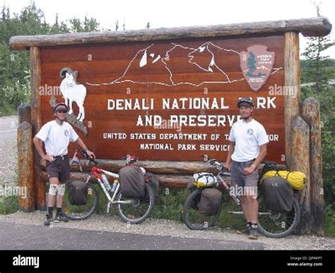 The George Parks Highway Scenic Byway - Bicyclists at the Denali National Park Welcome Sign ...