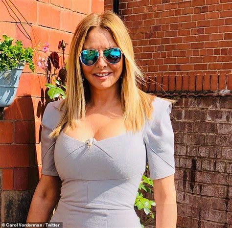 Carol Vorderman, 58, shows off her famous curves in figure-hugging blue dress at friend's ...