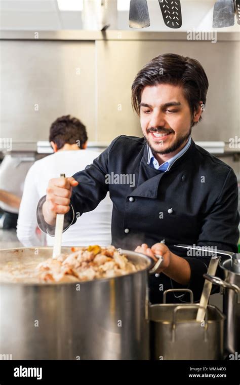 Chef stirring a huge pot of stew or casserole Stock Photo - Alamy