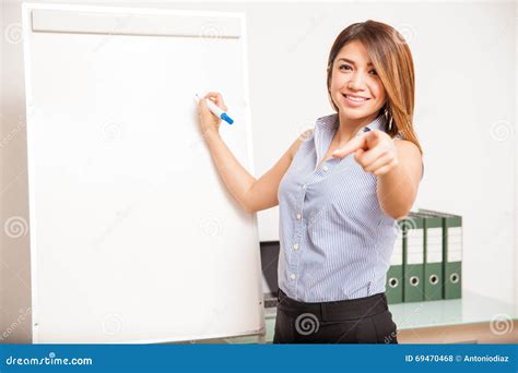 Pretty Teacher Asking A Question During Class Stock Photo - Image: 69470468