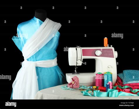 Sewing machine, dummy and other sewing equipment isolated on black ...