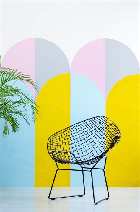 Premium Photo | Modern armchair set on a colorful wall next to a plant real pho