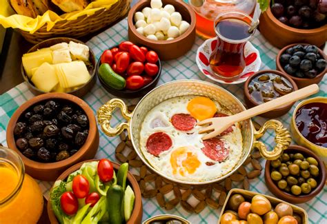 an assortment of food including eggs, olives, tomatoes, and other foods ...