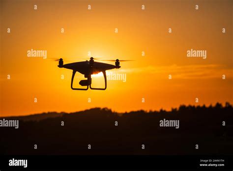 Silhouette of drone at sunset Stock Photo - Alamy