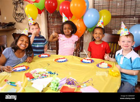 Group of children eating cake at birthday party Stock Photo - Alamy