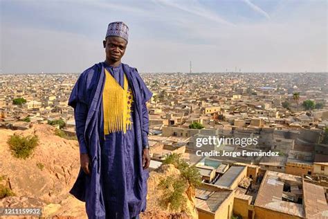 Portrait of a young man dressed in typical Hausa costume posing from ...