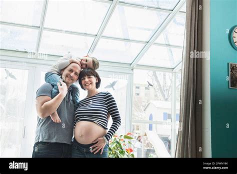 Portrait of parents carrying baby on shoulders Stock Photo - Alamy