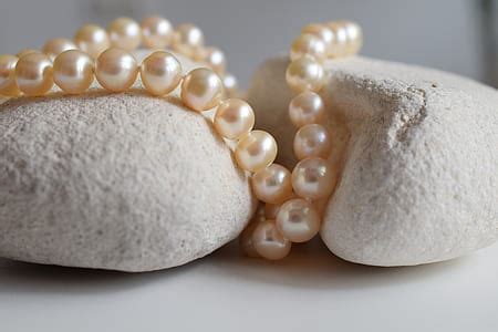 Royalty-Free photo: Silver-colored rings and white pearl necklace | PickPik