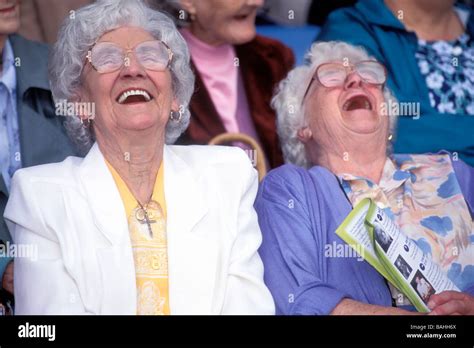 2 elderly ladies laughing at a pensioners event, Southwark, southeast ...