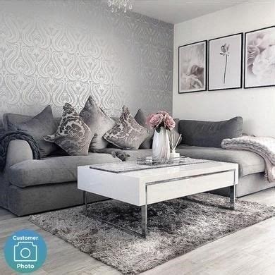 a living room with grey couches and white coffee table in front of a ...