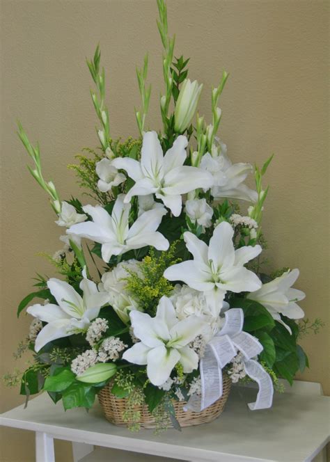 An all white flower arrangement including white lilies made by your local riverside florist ...