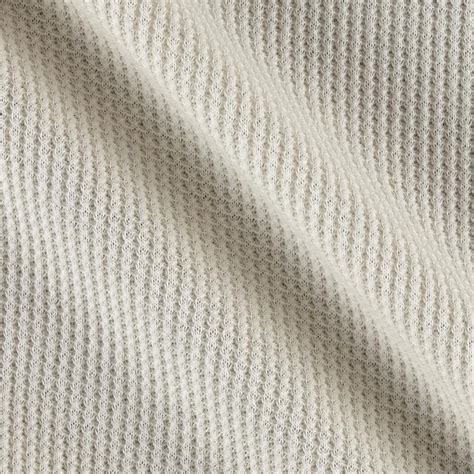 This lightweight cotton thermal knit fabric features a smooth hand and 15% stretch for added ...