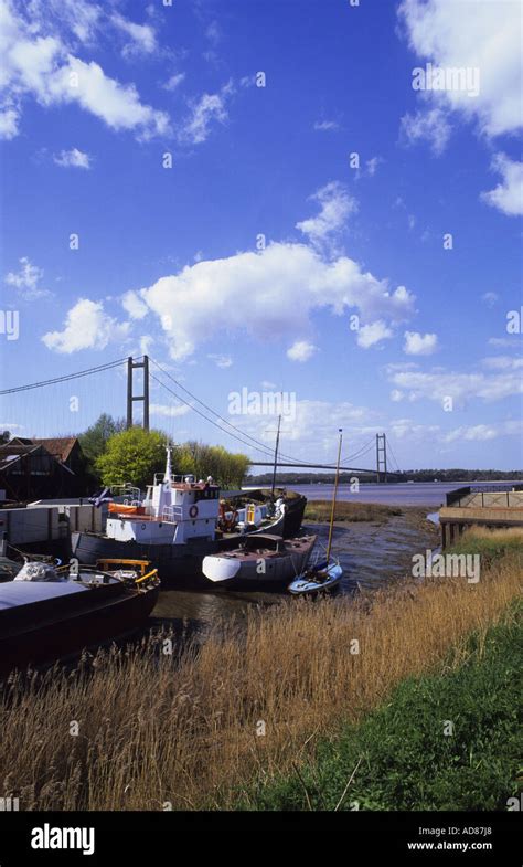 boats moored on the humber estuary with the humber bridge behind linking yorkshire with ...