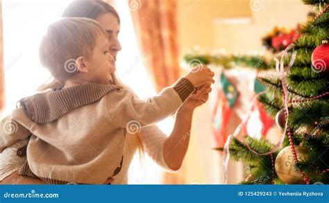 Closeup Image of Little Boy Adorning Christmas Tree with Mother Stock Image - Image of baubles ...