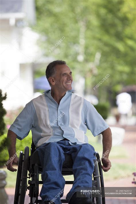 Man with spinal cord injury in a wheelchair enjoying outdoors — Casual ...