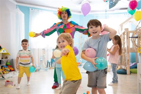 Clown at Children Birthday Party Entertaining Kids. Children Play with Ballons Stock Image ...