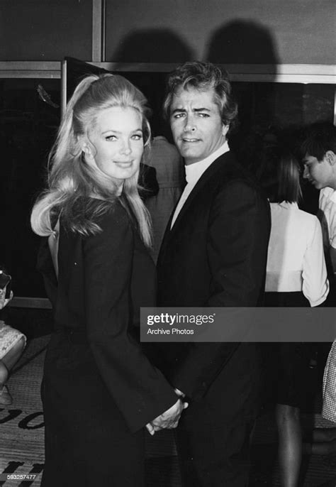 Actor John Derek and his wife Linda Evans holding hands at the Emmy ...