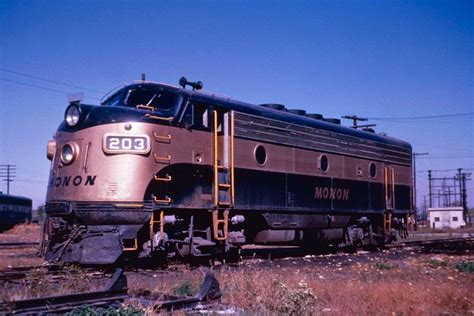 an old train is parked on the tracks near some power lines and telephone poles,