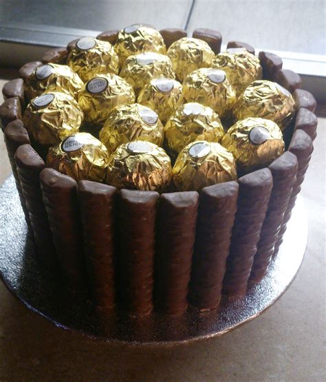 Giant 'Ferrero Rocher' cake. Chocolate cake, chocolate covered fudge bars, Ferrero Rocher ...