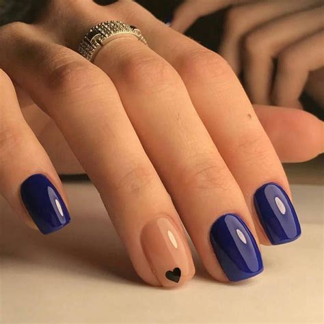 Beautiful Navy Blue nails with tiny Heart shape. pink nail polish on rounded shaped nail ...