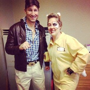 a man and woman dressed in costumes pose for a photo while standing next to each other