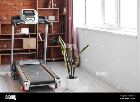 Interior of living room with modern treadmill Stock Photo - Alamy