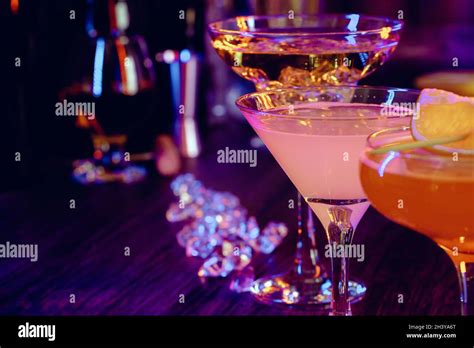 Two beautiful cocktails served on a wooden bar counter Stock Photo - Alamy