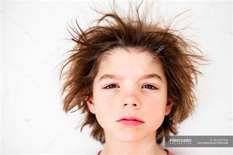 Portrait of a boy with messy hair — close up, serious - Stock Photo ...